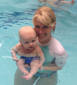 Former Newport Beach resident Anja Rex, now of Del Mar, starts to acclimate her son Alex to a water environment with a swimming lesson.